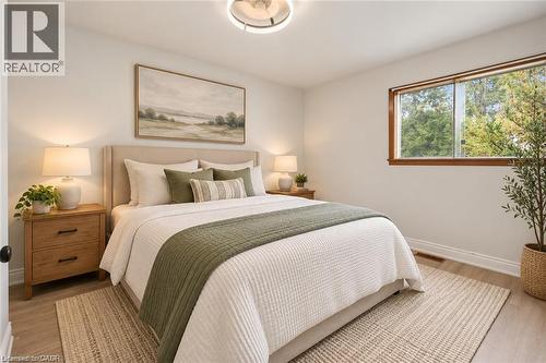 Neutral wall finishes, wood-finish flooring, recessed ceiling lighting, and a window with wood-trim detailing - 1279 Hamilton Street, Cambridge, ON 