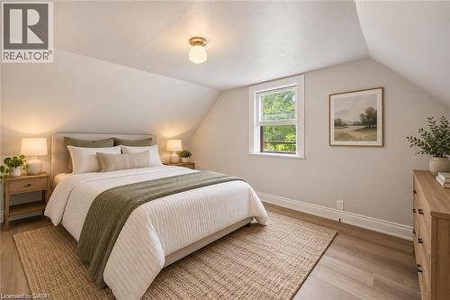 Room featuring wood-finish flooring, vaulted ceiling, and dual-pane window - 1279 Hamilton Street, Cambridge, ON 