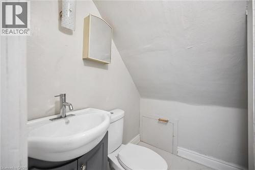 Wall-mounted medicine cabinet, pedestal sink with a single-handle chrome faucet, slate-grey vanity cabinet, and built-in access panel - 1279 Hamilton Street, Cambridge, ON 