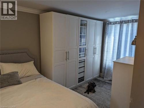 Custom white floor-to-ceiling cabinetry with integrated shelving, soft-close drawers, and glass-paneled display doors - 326 Ottawa Street, Hamilton, ON 