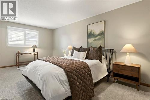 Neutral-toned walls, wall-to-wall carpeting, and interior window shutters - 53 Bastille Street, Hamilton, ON 