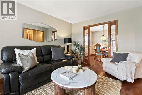 Hardwood flooring and interior French doors featuring wood frames and glass panels - 53 Bastille Street, Hamilton, ON 