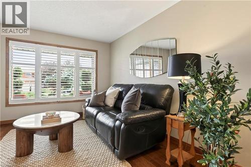 Interior space featuring wood-finish flooring, multi-pane windows, and interior plantation shutters - 53 Bastille Street, Hamilton, ON 