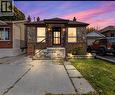 Exterior facade featuring stone and brick masonry, covered front porch with metal railings, concrete driveway, and attached garage - 81 East 23Rd Street, Hamilton, ON 