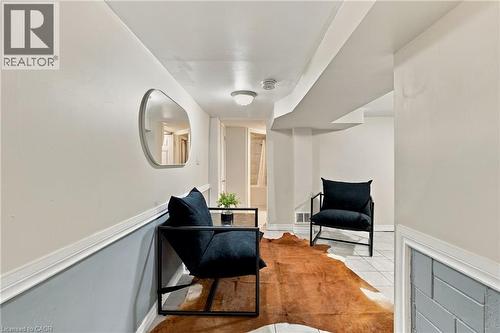 Interior space featuring two-tone wall paint with applied chair rail molding, ceiling-mounted lighting, and ceramic tile flooring - 81 East 23Rd Street, Hamilton, ON 