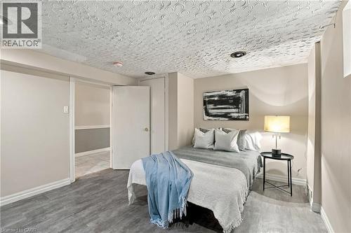 Textured ceiling with integrated recessed lighting and wood-finish flooring - 81 East 23Rd Street, Hamilton, ON 