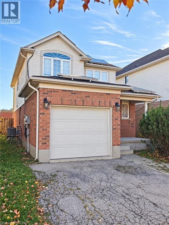 Two-story exterior featuring a brick and siding facade, an attached garage, and a covered front entry - 52 Isabella Street, Kitchener, ON