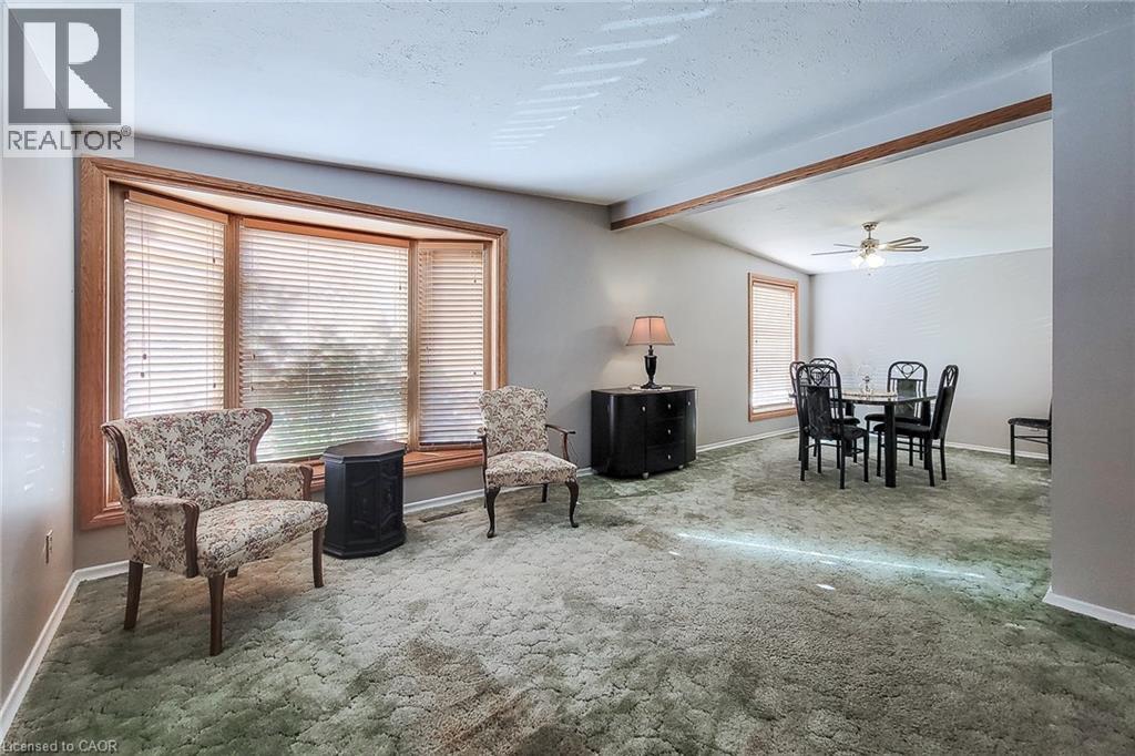 Bright living and dining areas with large windows and a comfortable open connection between spaces - 286 Mohawk Road W, Hamilton, ON