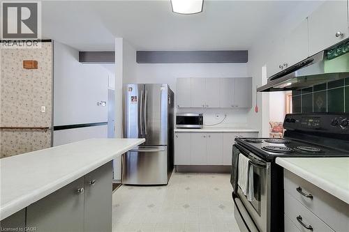 Traditional kitchen layout with generous counter space and convenient access to the dining area - 286 Mohawk Road W, Hamilton, ON 