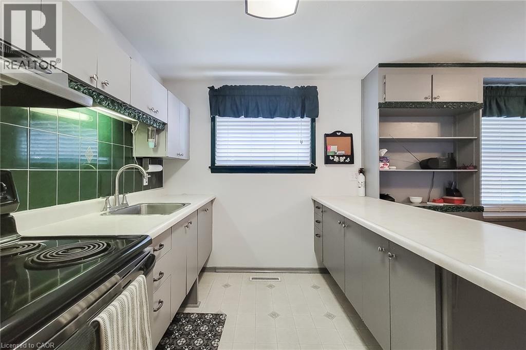 Efficient kitchen design with ample cabinetry and countertop space - 286 Mohawk Road W, Hamilton, ON