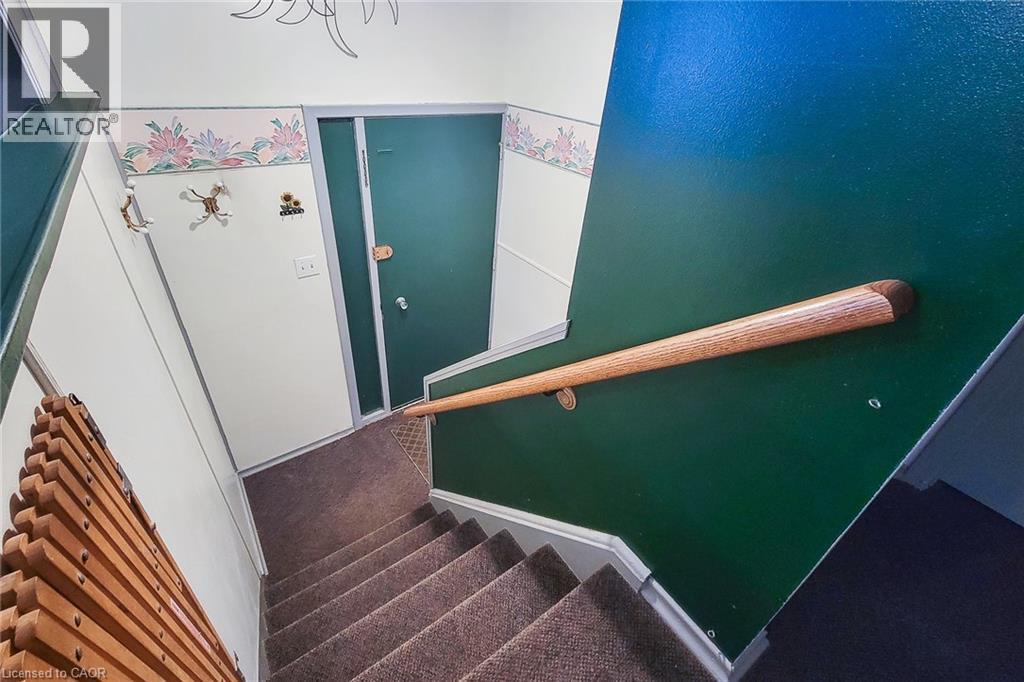 Interior staircase leading to the spacious lower level with plenty of future possibilities - 286 Mohawk Road W, Hamilton, ON