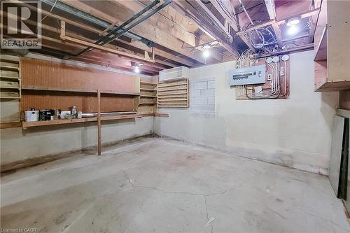 Unfinished workshop area with built-in shelving and plenty of room for tools and projects - 286 Mohawk Road W, Hamilton, ON 