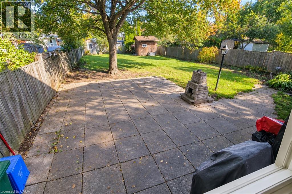 Generous backyard patio offering plenty of space for outdoor seating and entertaining - 286 Mohawk Road W, Hamilton, ON