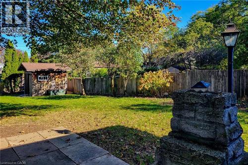 Enjoy outdoor living with a spacious patio and mature trees overlooking the generous backyard - 286 Mohawk Road W, Hamilton, ON 