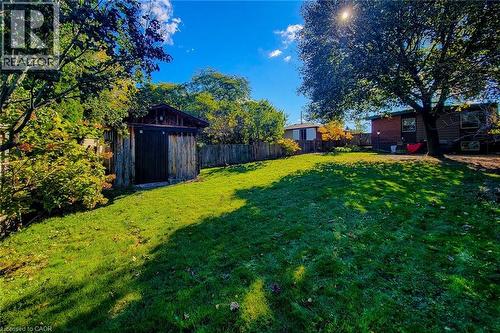 Deep backyard with mature landscaping and a handy garden shed for outdoor storage - 286 Mohawk Road W, Hamilton, ON 