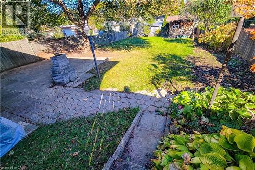Generous backyard with mature trees and patio space on an impressive 156-foot-deep lot - 286 Mohawk Road W, Hamilton, ON 