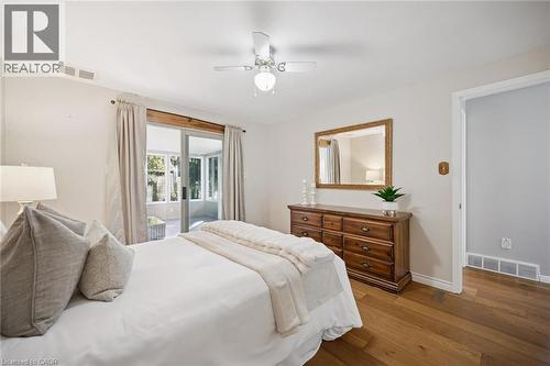 Wood-finish flooring, ceiling fan with integrated lighting, and sliding glass door - 11 Caledon Court, Cambridge, ON 