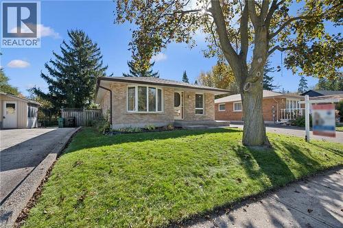 Single-story brick exterior featuring a front-facing bay window, paved private driveway, and mature landscaping - 11 Caledon Court, Cambridge, ON 