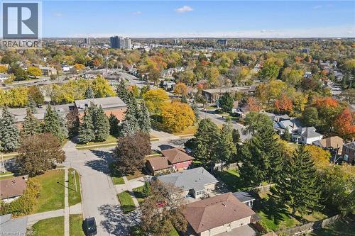 Aerial perspective of a suburban neighborhood featuring mature tree canopy, residential street infrastructure, and asphalt driveways - 11 Caledon Court, Cambridge, ON 