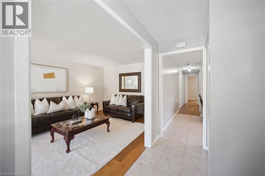 Neutral interior palette with wood-finish flooring and ceramic tile entry - 11 Caledon Court, Cambridge, ON