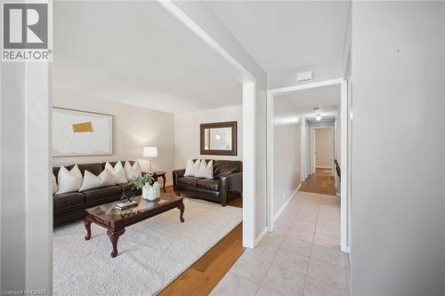 Neutral interior palette with wood-finish flooring and ceramic tile entry - 11 Caledon Court, Cambridge, ON 