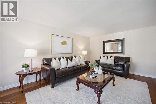 Living area featuring wood-finish flooring and neutral wall color - 11 Caledon Court, Cambridge, ON 