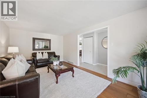 Neutral wall tones featuring wood-finish flooring and a white interior door - 11 Caledon Court, Cambridge, ON 