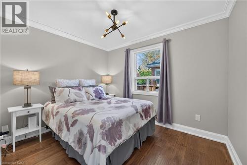 Main Floor Bedroom features crown moulding and gorgeous flooring. - 10 Mulock Avenue, Hamilton, ON 