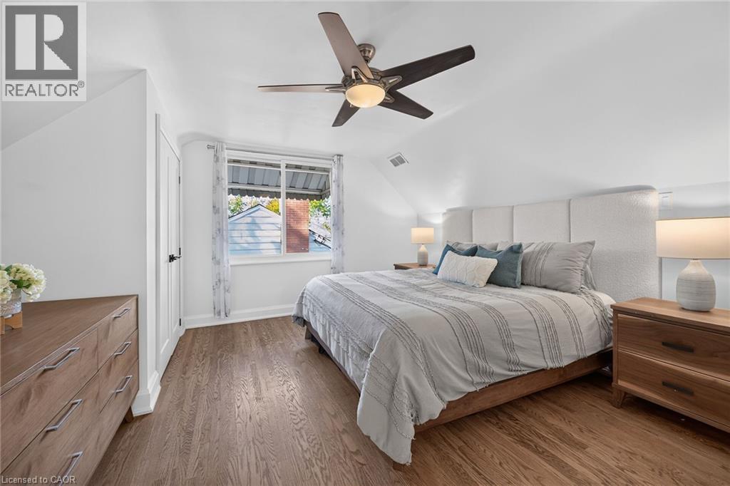 Primary bedroom features refinished original oak flooring and dual closets. - 10 Mulock Avenue, Hamilton, ON