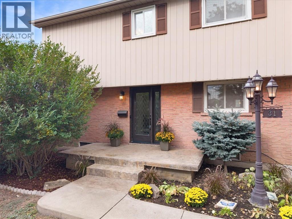 Brick and vertical siding exterior with contrasting window shutters - 31 Berrisfield Crescent, Hamilton, ON