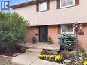 Brick and vertical siding exterior with contrasting window shutters - 31 Berrisfield Crescent, Hamilton, ON 