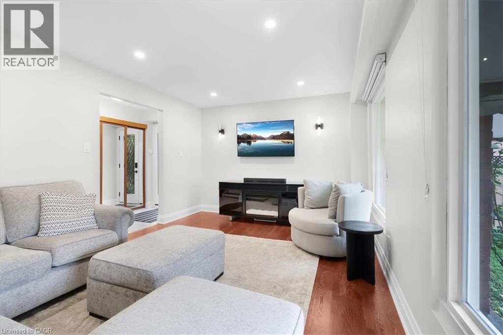 Hardwood-finish flooring, recessed lighting, and wall-mounted sconces - 31 Berrisfield Crescent, Hamilton, ON