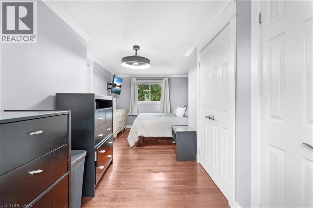 Wood-finish flooring with white trim - 31 Berrisfield Crescent, Hamilton, ON