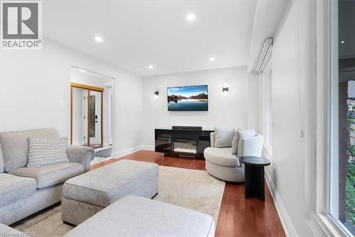 Hardwood-finish flooring, recessed lighting, and wall-mounted sconces - 31 Berrisfield Crescent, Hamilton, ON 