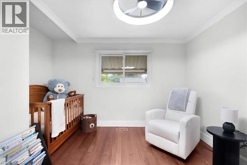 Wood-finish flooring, white walls, and a contemporary ceiling light fixture - 31 Berrisfield Crescent, Hamilton, ON 