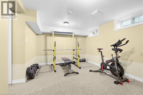 Carpeted room with painted walls, recessed lighting, and two white-trimmed windows - 31 Berrisfield Crescent, Hamilton, ON 
