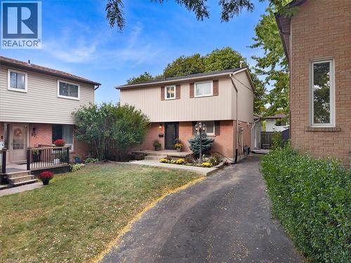 Brick and siding exterior with mature landscaping - 31 Berrisfield Crescent, Hamilton, ON 