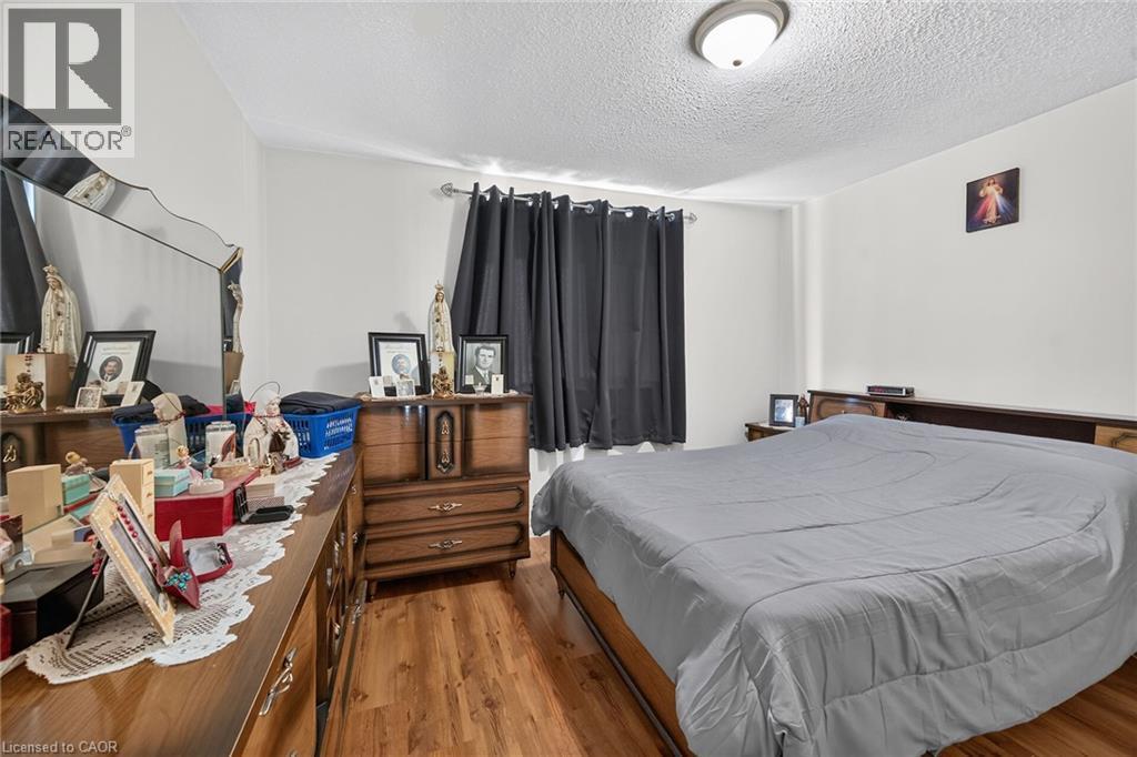 Wood-finish flooring and a central ceiling-mounted dome light fixture - 411 Queen Victoria Drive, Hamilton, ON