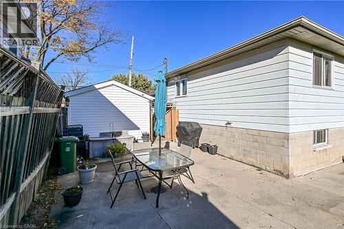 Concrete patio featuring a detached storage structure and privacy fencing - 411 Queen Victoria Drive, Hamilton, ON 