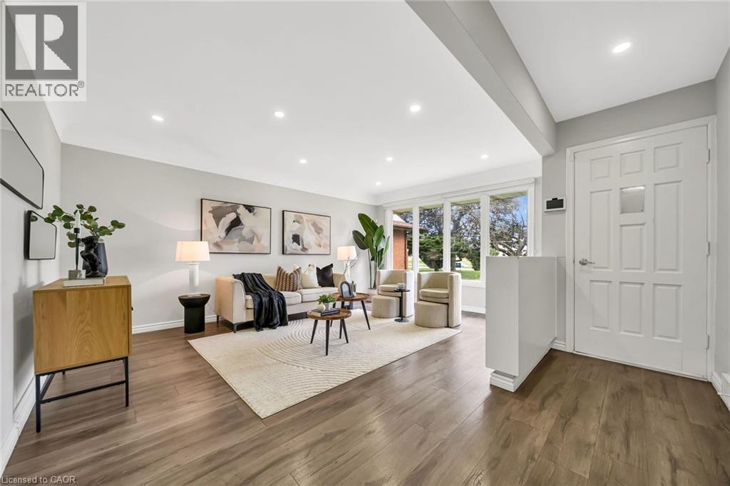Recessed lighting throughout, wide plank wood-finish flooring, and a multi-pane front door - 284 Cedar Crescent, Cambridge, ON - Indoor