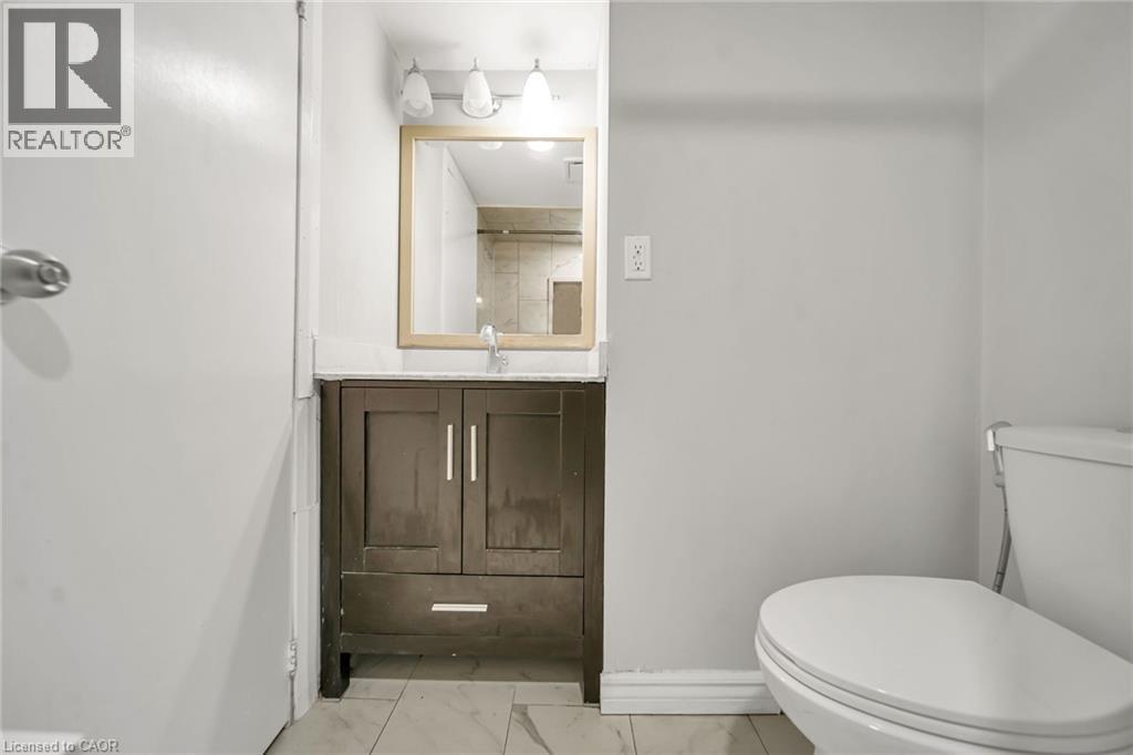 Dark wood-finish vanity with a white countertop - 284 Cedar Crescent, Cambridge, ON - Indoor Photo Showing Bathroom