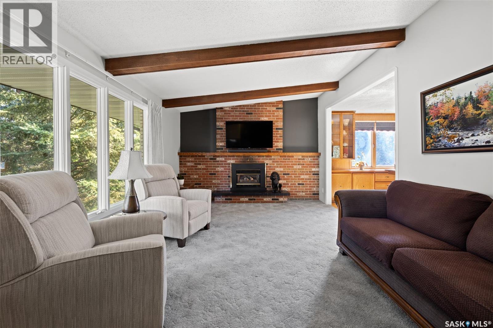 23 Ridgedale Bay, White City, SK - Indoor Photo Showing Living Room With Fireplace
