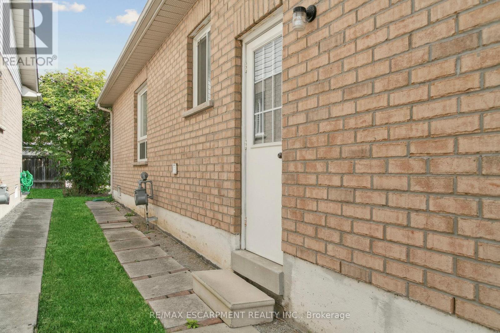 Side door from garage and walkway to backyard - 245 Centennial Forest Drive, Milton, ON - Outdoor With Exterior
