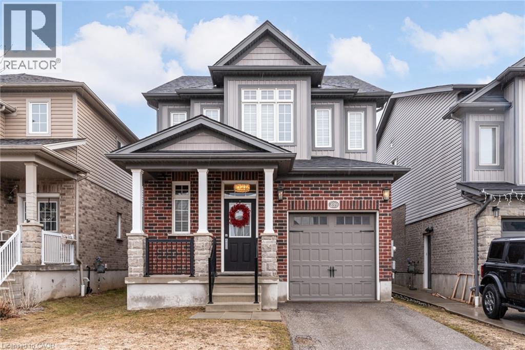 Craftsman house featuring asphalt driveway, a porch, and brick siding - 239 Cranbrook Street, Kitchener, ON - Outdoor With Facade