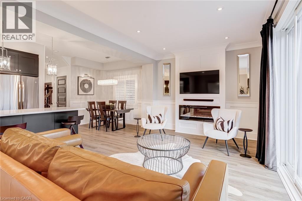 Living room with a decorative wall, a wainscoted wall, light wood finished floors, and recessed lighting - 239 Cranbrook Street, Kitchener, ON - Indoor Photo Showing Living Room With Fireplace