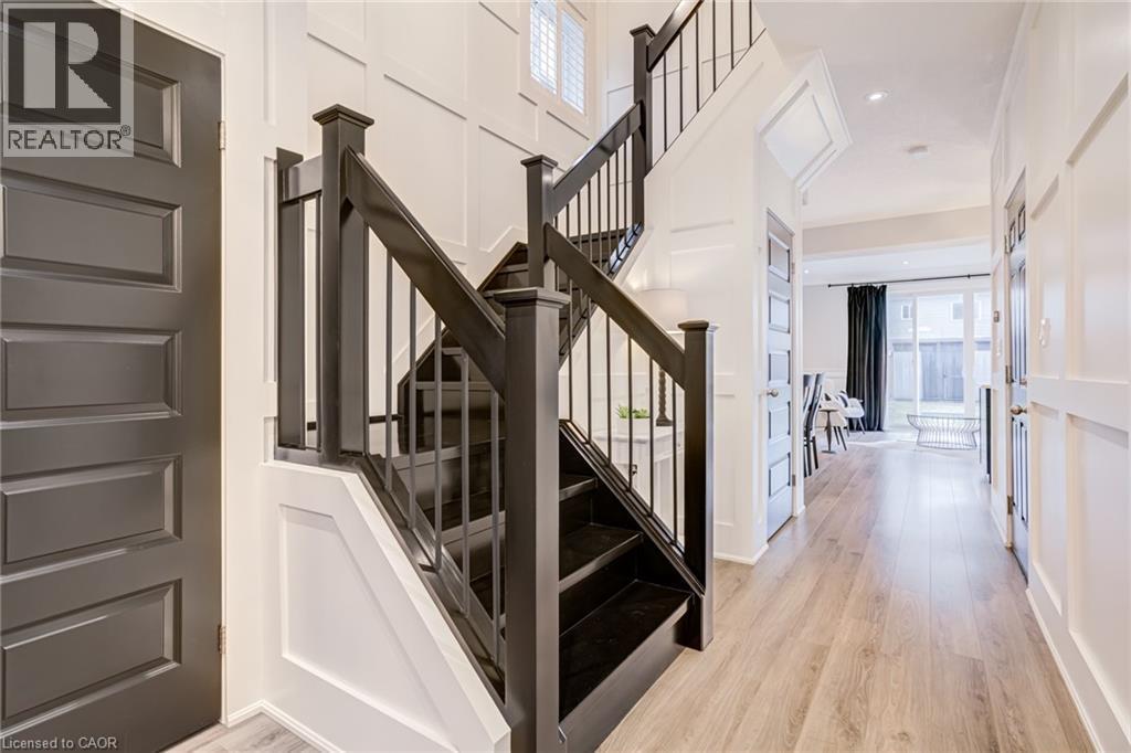 Stairway featuring wood finished floors, a high ceiling, and a decorative wall - 239 Cranbrook Street, Kitchener, ON - Indoor Photo Showing Other Room