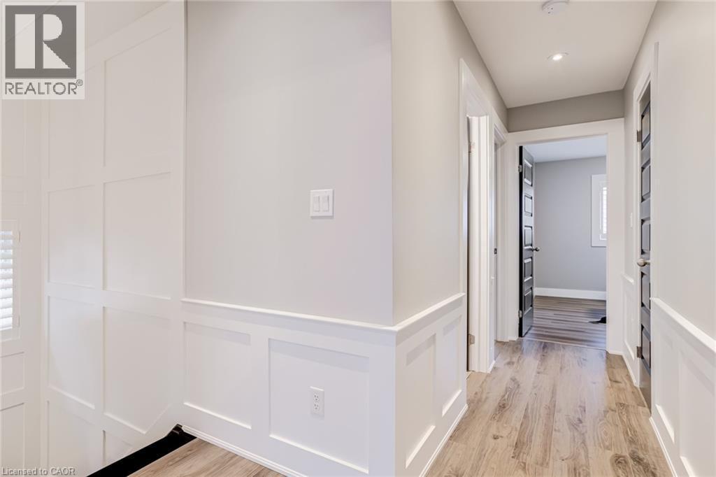 Hallway with light wood-style flooring, recessed lighting, and a decorative wall - 239 Cranbrook Street, Kitchener, ON - Indoor Photo Showing Other Room