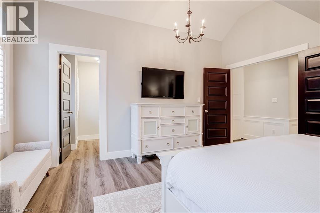 Bedroom featuring a chandelier, light wood-style flooring, and lofted ceiling - 239 Cranbrook Street, Kitchener, ON - Indoor Photo Showing Bedroom