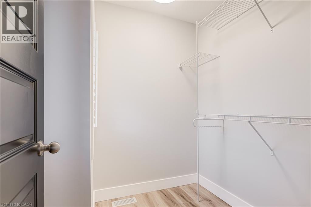 Walk in closet with light wood finished floors - 239 Cranbrook Street, Kitchener, ON - Indoor With Storage