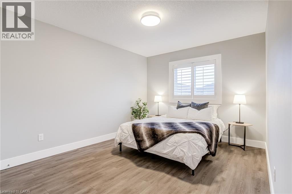 Bedroom featuring light wood-style floors and a textured ceiling - 239 Cranbrook Street, Kitchener, ON - Indoor Photo Showing Bedroom